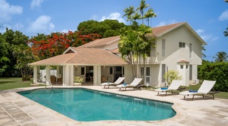Pool and sun loungers below the flamboyant tree at 149 Salters Road, luxury villa in Sandy Lane, Barbados