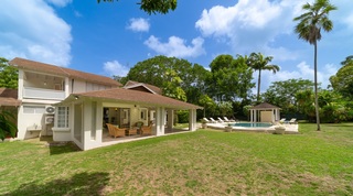 Wide garden lawn and covered terrace with the pool beyond at 149 Salters Road, St. James, Barbados