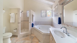 En-suite bathroom with a corner tub and walk-in shower at 149 Salters Road, Barbados