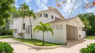 White two-storey facade and curved driveway at 149 Salters Road, a holiday villa in Barbados
