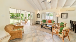 Sitting room with rattan armchairs under a beamed ceiling, 149 Salters Road, Barbados