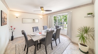 Dining room at 149 Salters Road set beneath a casement window onto the garden, Barbados