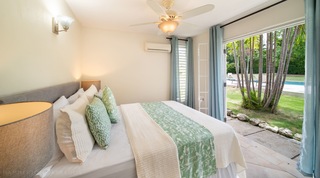 Double bedroom with green accents opening to the garden, 149 Salters Road, Barbados