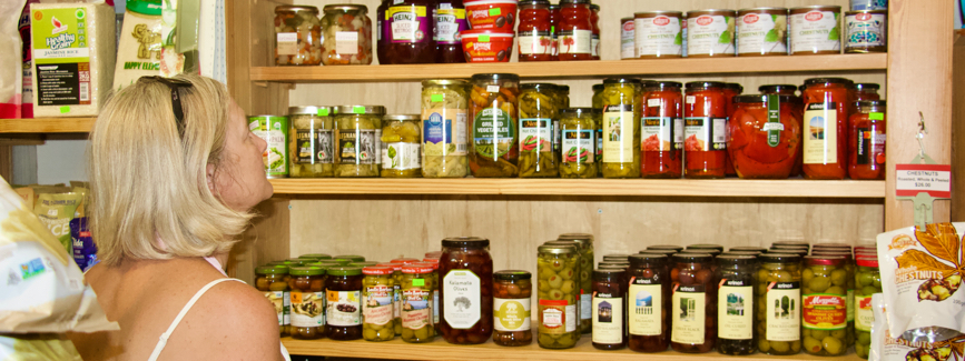 Lisa looking at jars of produce on the shelves