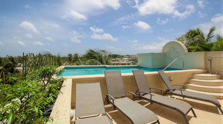 Rooftop sun loungers beside the communal pool at Beacon Hill 305 – The Penthouse, apartments in Barbados