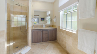 En suite with a walk-in rainfall shower and twin basins at Bella Vista villa, Barbados