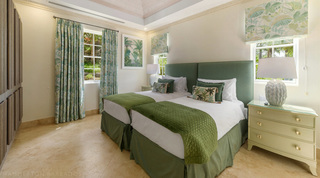 Twin beds with green throws and palm-leaf cushions at Bella Vista, private villa in Barbados