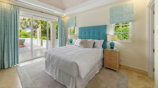 Buttoned turquoise headboard and matching table lamps in a Bella Vista bedroom, Barbados
