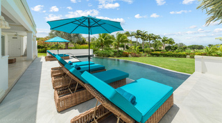 Cushioned loungers along the pool with golf fairway views at Bella Vista, luxury villa in Barbados