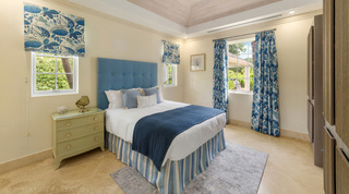 Blue botanical curtains and a striped valance in a guest bedroom at Bella Vista, Barbados