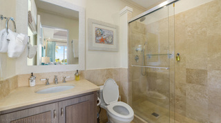 Sliding shower enclosure and a shell print in an en suite at Bella Vista villa, Barbados