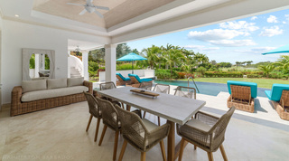 Terrace dining and wicker sofa opening to the pool at Bella Vista, holiday villa in Barbados