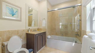 Bath with overhead rainfall shower and sea fan print at Bella Vista villa, St. James, Barbados
