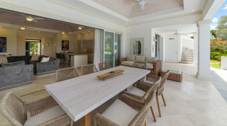 Bella Vista's long terrace table set beside the open-plan living room, Barbados