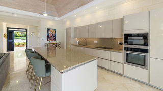 Kitchen island with three sage bar stools and double ovens at Bella Vista, Barbados