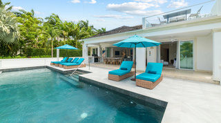 Poolside loungers below the rooftop terrace at Bella Vista, a holiday villa in Barbados