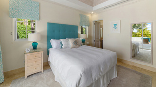 Turquoise bedroom with a jellyfish print and full-length mirror at Bella Vista, Barbados