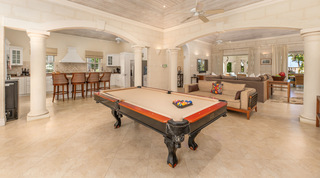 Pool table beside the kitchen breakfast bar and stone arches at Carlton Ridge villa rental, Barbados