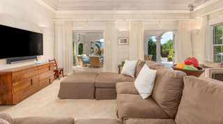 Sectional seating beneath a whitewashed plank ceiling in the living room at Carlton Ridge, Barbados