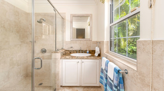 Shower room with travertine tiling and a window onto the palms, Carlton Ridge, St. James, Barbados
