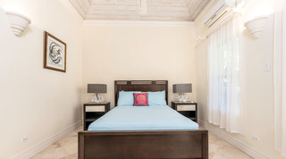 Coral form table lamps and gilt framed artwork in a bedroom at Carlton Ridge, St. James, Barbados