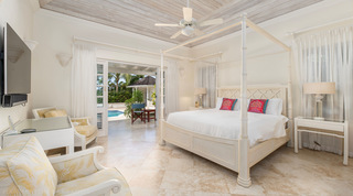 Master bedroom with a cream four-poster opening to the pool terrace, Carlton Ridge luxury villa, Barbados