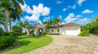 Coral stone entrance portico and circular paver drive at Carlton Ridge, a private villa in Barbados
