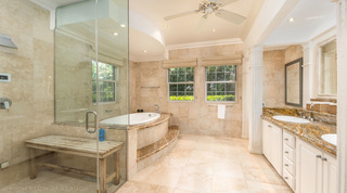 Walk-in shower, oval bath and a double granite vanity in the bathroom at Carlton Ridge, Barbados