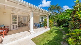 Columned veranda with ceiling fans opening to the sitting room at Carlton Ridge villa, St. James, Barbados