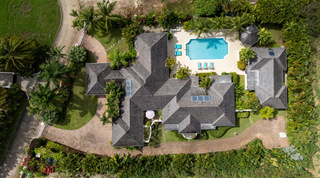 Shingle roofs, the guest cottage and lawns seen from above at Carlton Ridge, Barbados villa rental