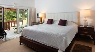 King bedroom with sliding doors onto a private terrace at Church Point 2, luxury villa in Barbados