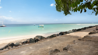 Calm turquoise sea and a shaded seafront path beside the beach at Church Point 2, Barbados