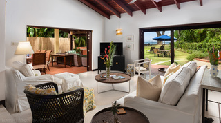 Living room with white sofas opening to the terrace and garden at Church Point 2 villa, Barbados