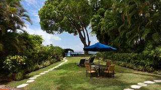 Treetops above the garden glimpsed past a corrupted grey image frame at Church Point 2, villa in Holetown, Barbados