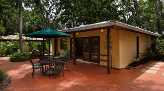 Self-contained cottage with a terracotta patio and shaded dining at Church Point 2 villa, Barbados