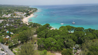 Aerial view of the coast with catamarans and leafy beachfront gardens at Church Point 2, Barbados