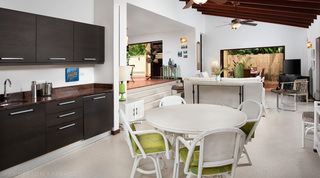 Wet bar and casual dining table beside the sitting room at Church Point 2 villa, Barbados