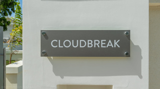 Entrance nameplate at Cloudbreak, one of the contemporary villas in Barbados, set on a rendered garden wall