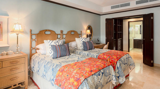 Twin room at Coral Cove 14 – Crowsnest in Barbados, its folding doors open to the wardrobe and en suite