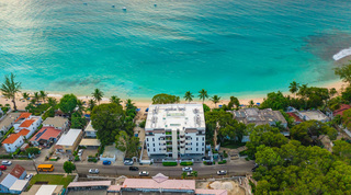 Aerial of moored boats and the white Coral Cove building on Paynes Bay, Coral Cove 14 – Crowsnest luxury apartment, Barbados