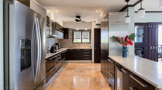 Kitchen at Coral Cove 14 – Crowsnest in Barbados, dark wood cabinets with long steel handles and a hexagon mosaic splashback