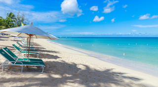 Green sun loungers lettered Coral Cove beneath a white parasol on Paynes Bay, Coral Cove 14 – Crowsnest in Barbados