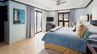 Balcony doors, a shuttered window and blue abstract art in a bedroom at Coral Cove 14 – Crowsnest, apartment in Barbados