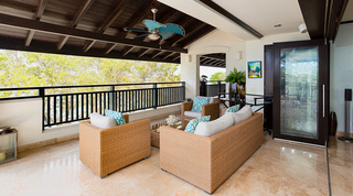 Under the beamed terrace roof at Coral Cove 14 – Crowsnest in Barbados, a wicker sofa and armchairs with lattice cushions