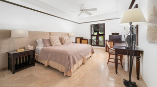 Third bedroom with king bed and writing desk by louvred doors at Coral Cove 15 - Penthouse, Barbados