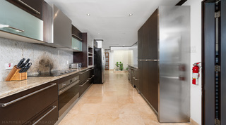 Galley kitchen with granite worktops and stainless steel appliances at Coral Cove 15 - Penthouse, Barbados