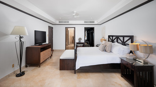 King bedroom with walk-in wardrobe and en-suite beyond at Coral Cove 15 - Penthouse, apartments in Barbados