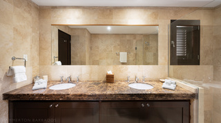 En-suite with twin basins and brown marble vanity at Coral Cove 15 - Penthouse, luxury apartment Barbados