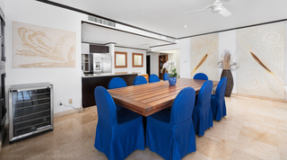 Dining room seating eight with blue slip-covered chairs at Coral Cove 15 - Penthouse, holiday apartments Barbados
