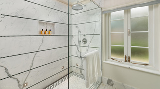 Walk-in marble shower banded with green mosaic tiles at Crystal Springs, private villas in Barbados